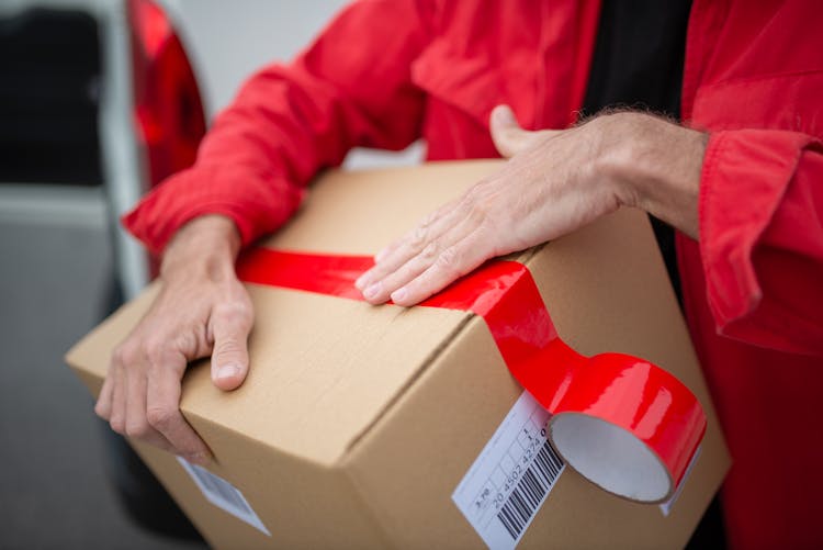 A Person Carrying A Box