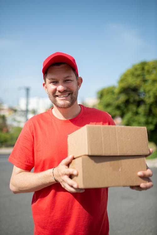 Free A Deliveryman Holding Delivery Boxes Stock Photo