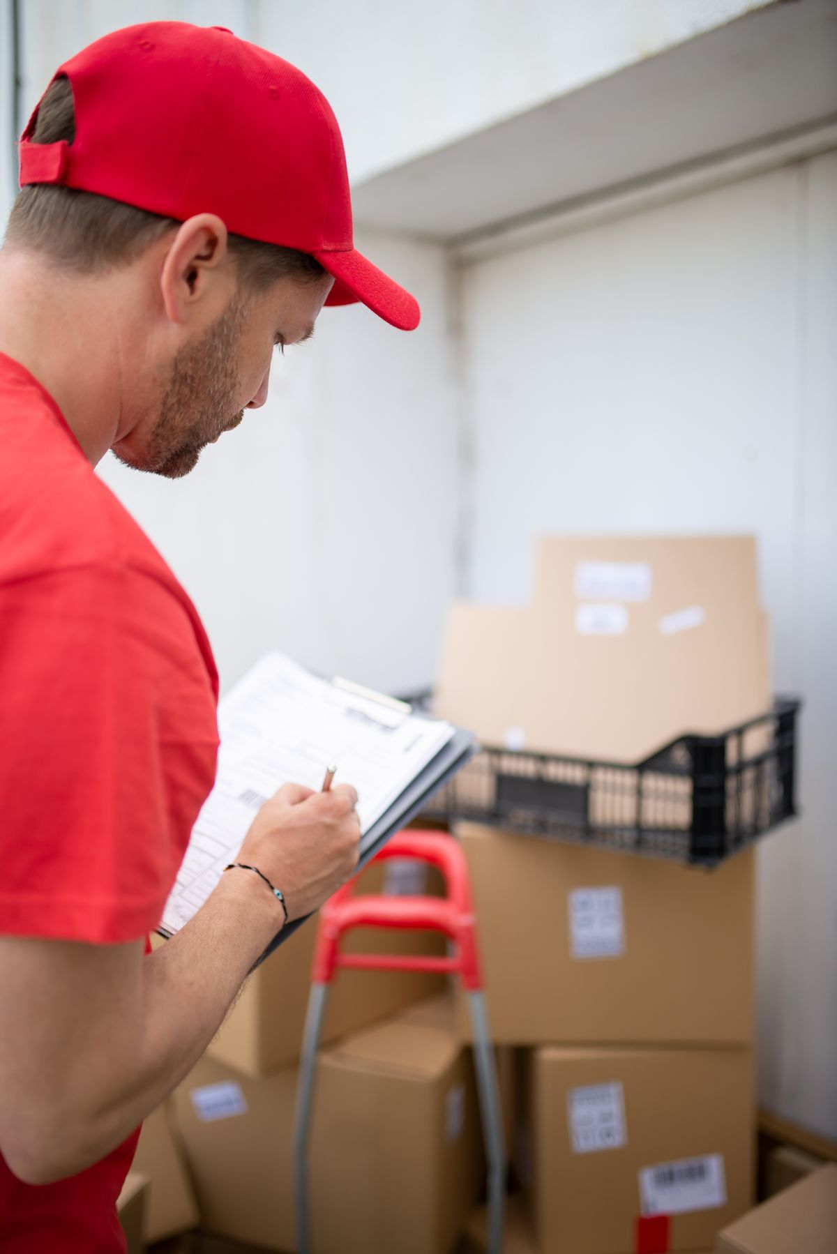 Logistics worker checking a clipboard in a warehouse