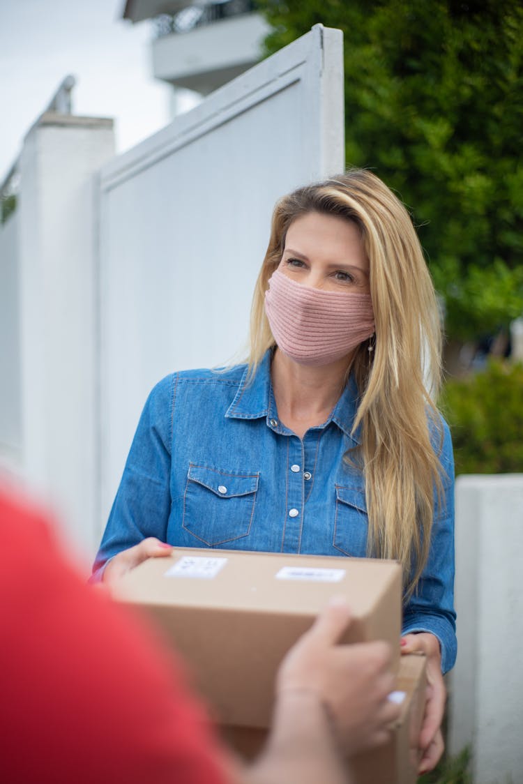 A Woman Receiving A Parcel