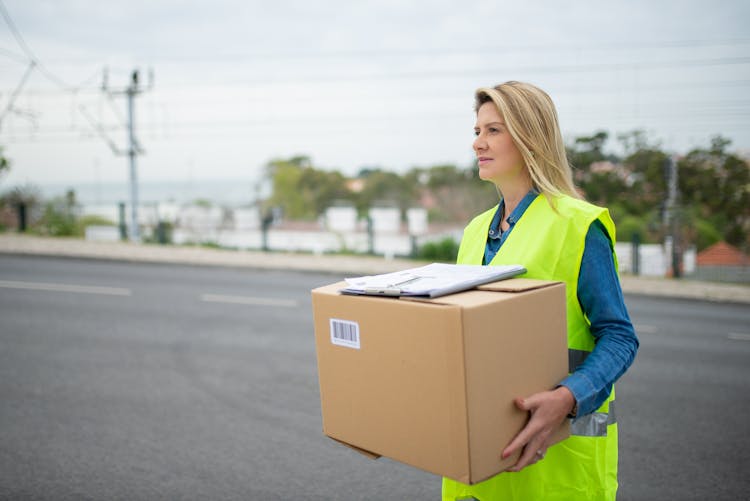 A Woman Carrying A Box