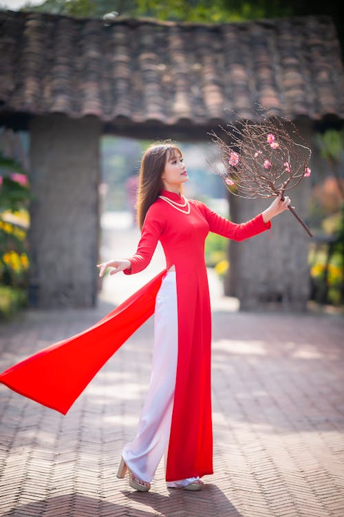 A Woman Wearing a High Slit Red Dresss