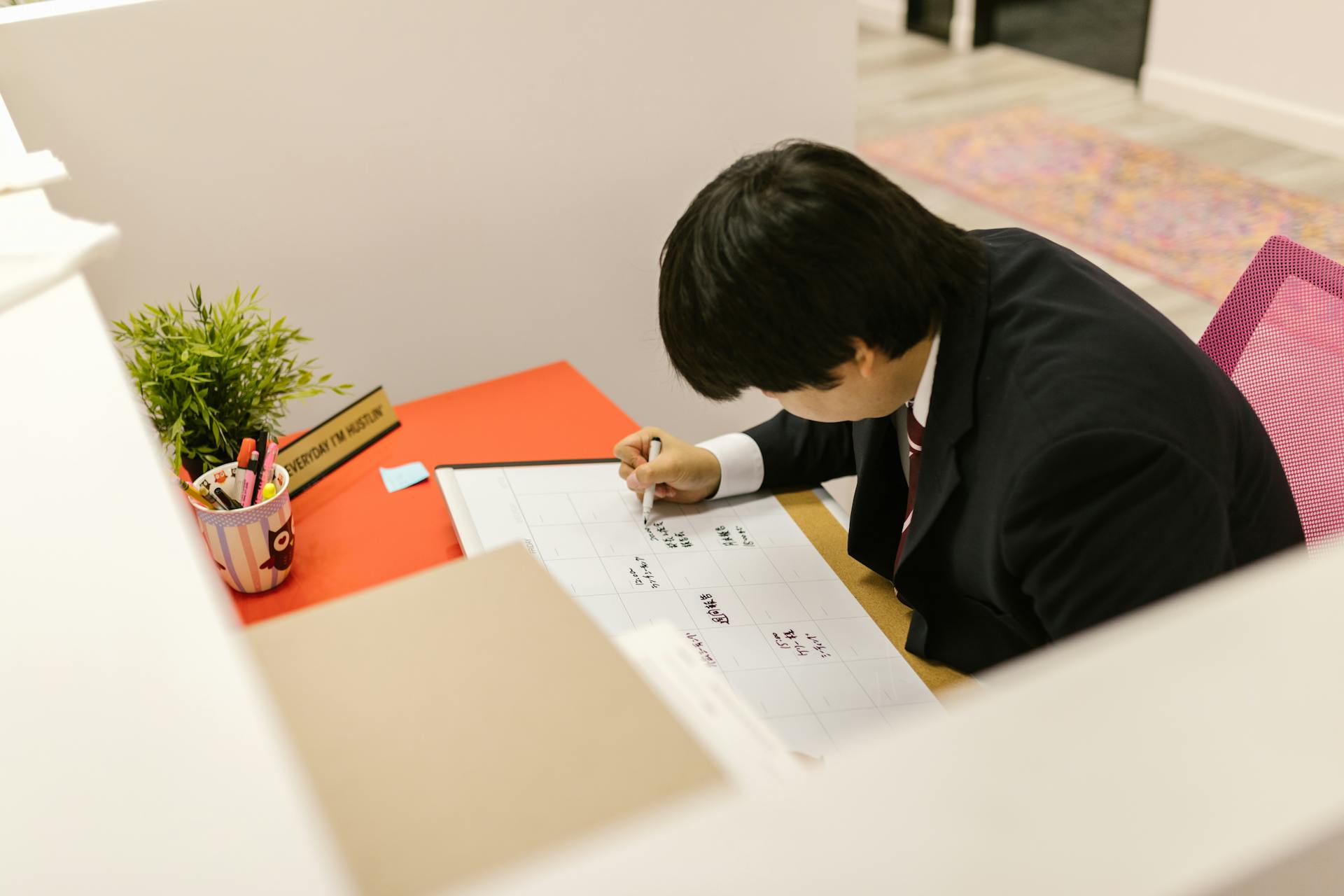 Man in Office Preparing Schedule