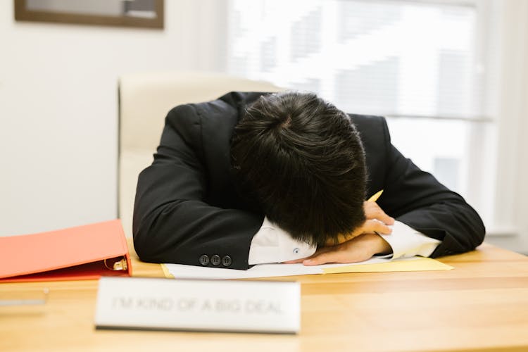 A Businessperson Sleeping On A Desk