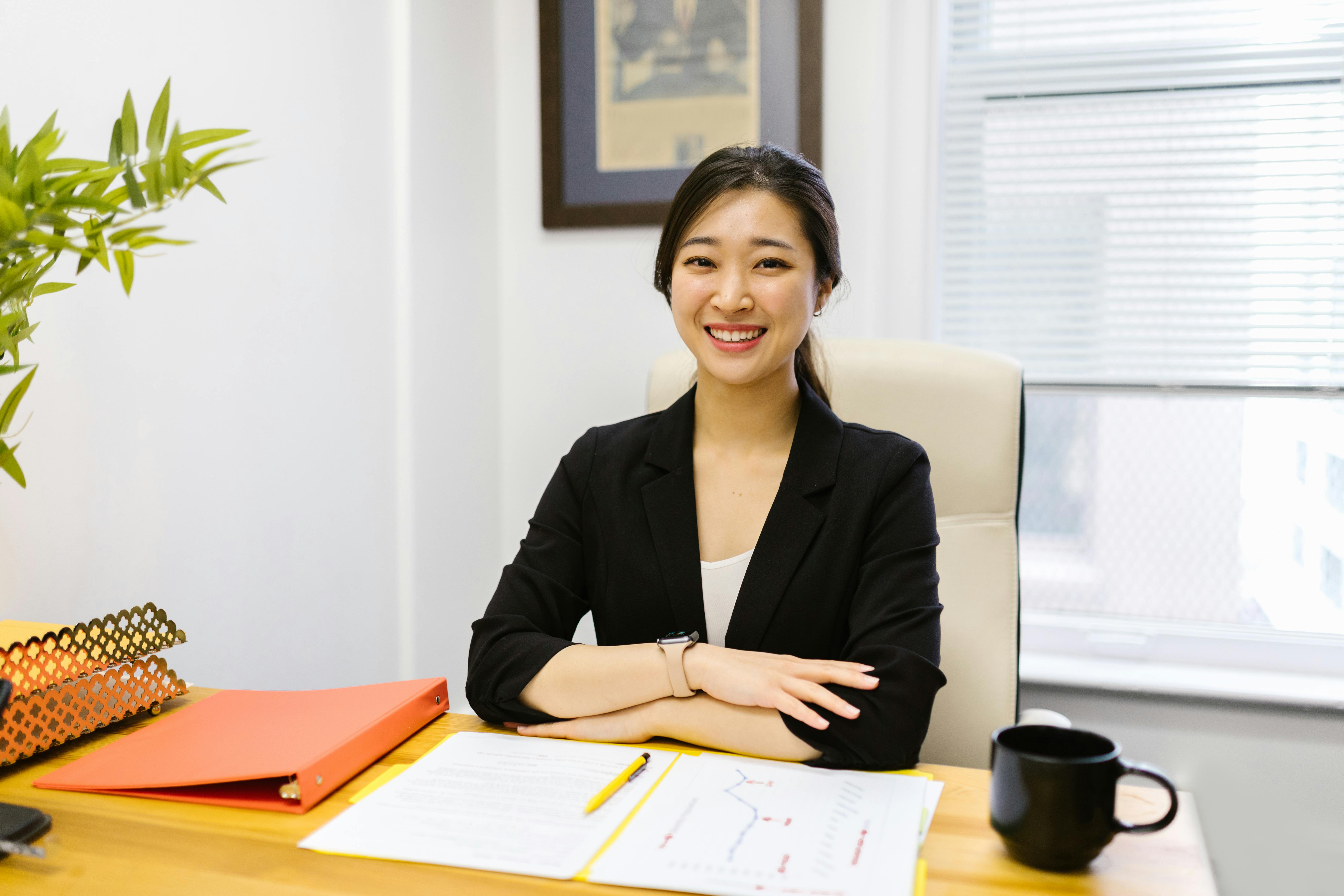 Business owner looking confident and relieved while reviewing compliance documents at their desk - e verify employer agent service