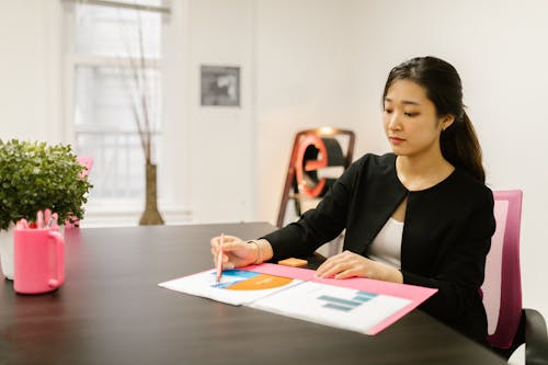 Free A Woman Doing Paper Works in the Office Stock Photo
