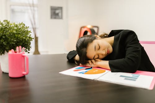 Free A Woman Taking a Nap on the Table Stock Photo