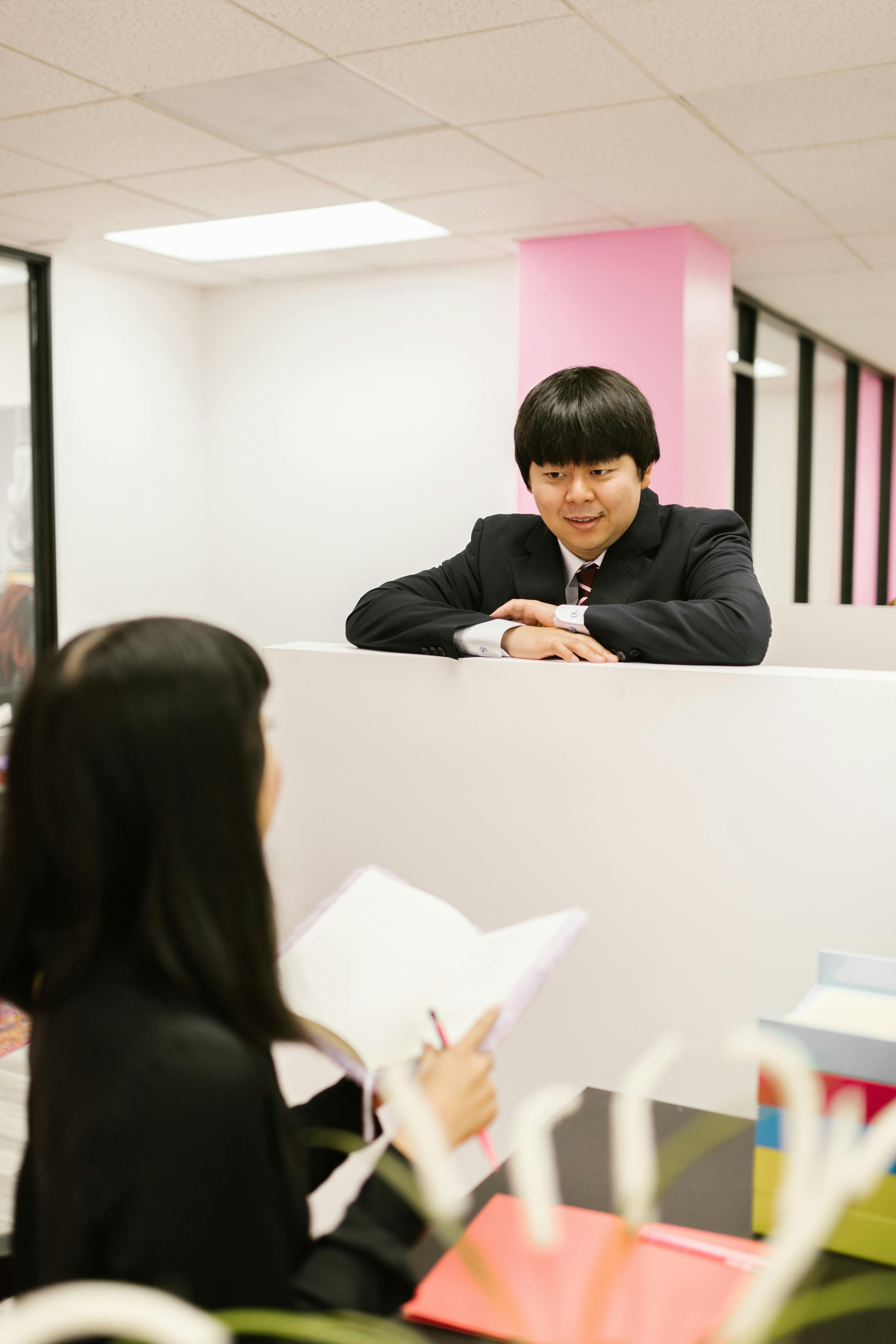 Business professionals engaged in conversation at a contemporary office.