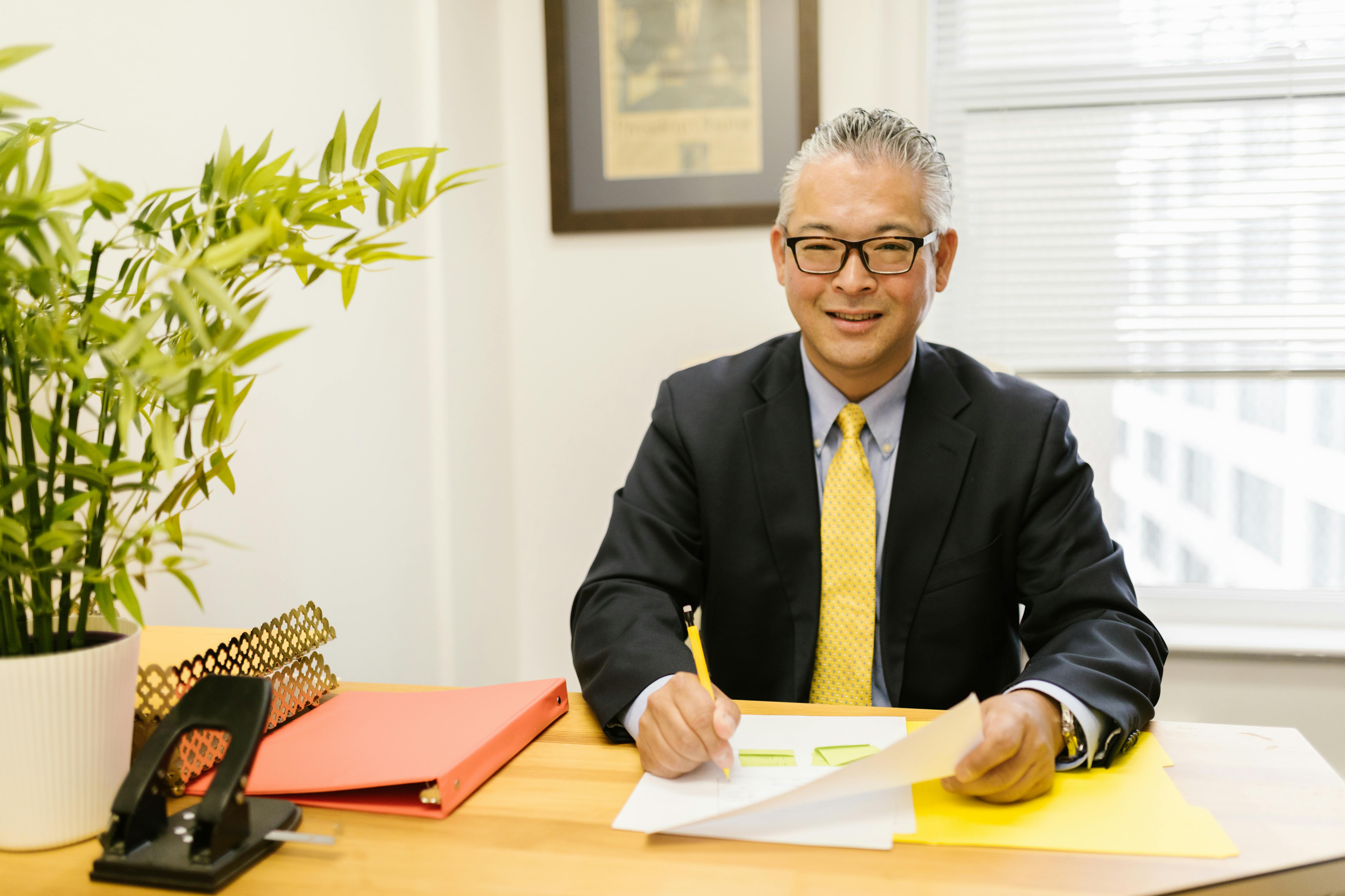 a happy man sitting at an office