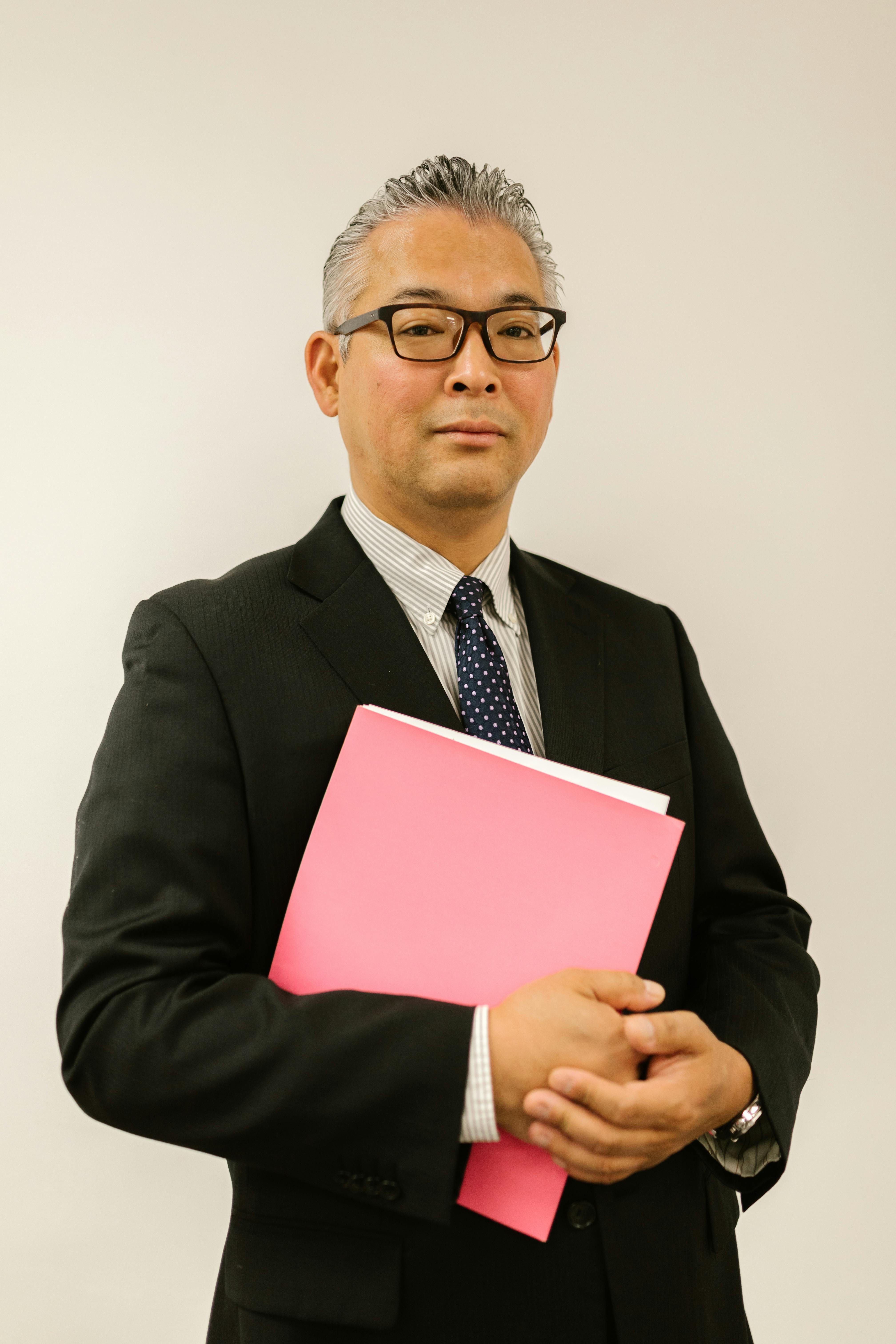 man in business attire wearing eyeglasses