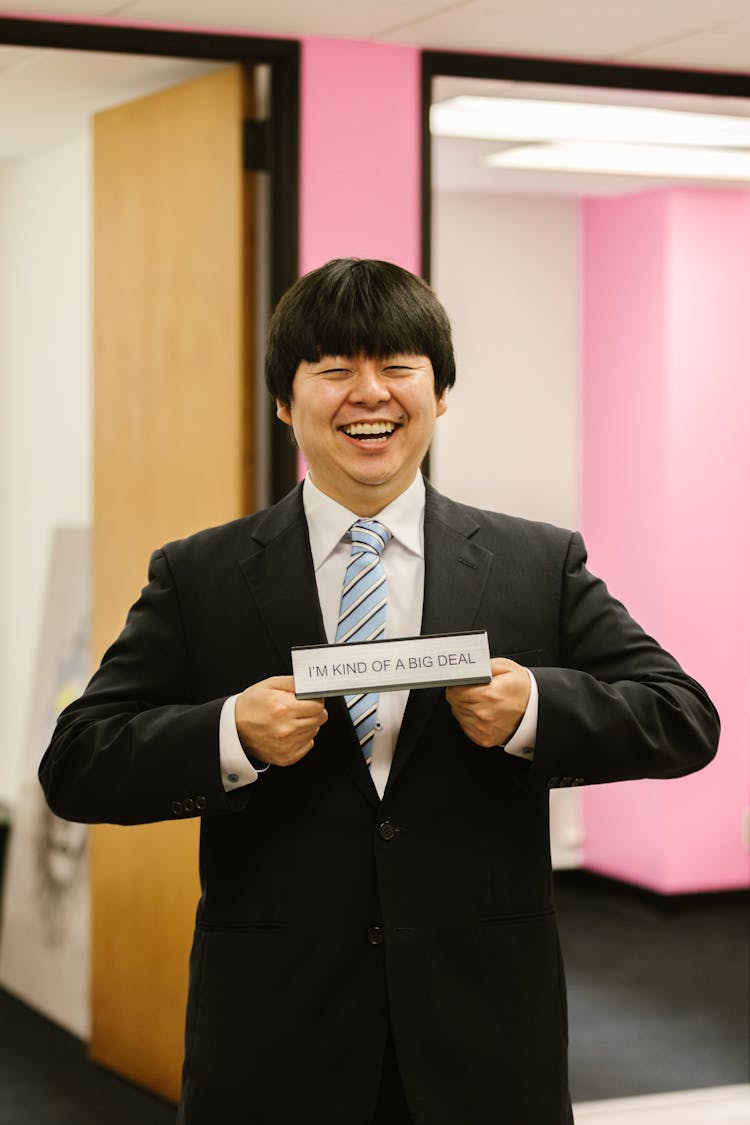 A Man In Black Suit Smiling