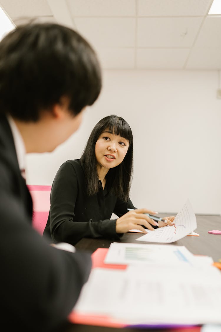 A Woman Discussing A Chart