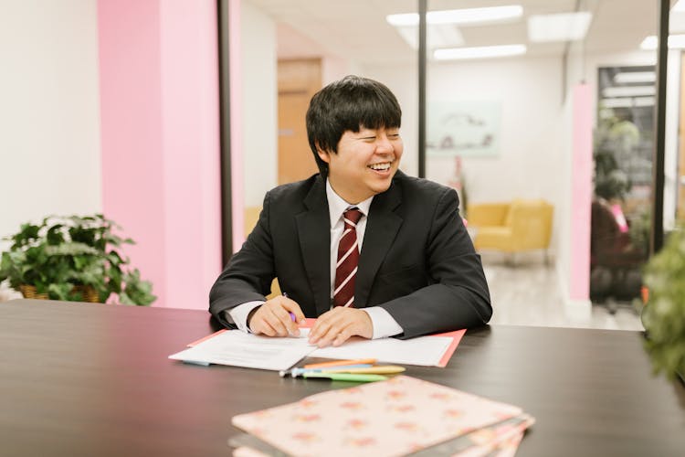 Smiling Businessman At Corporate Meeting