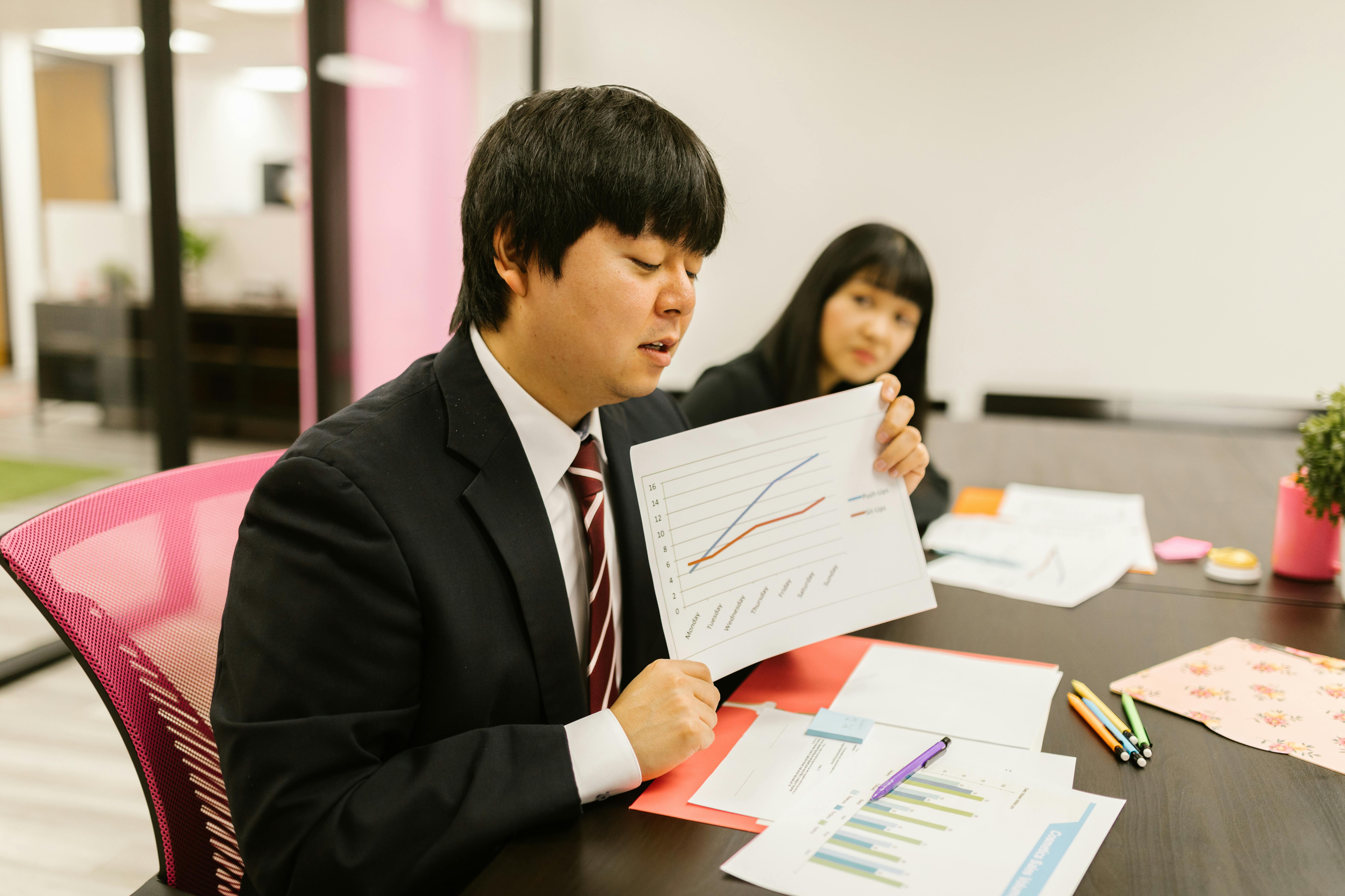 Business professionals discussing data during a meeting in a modern office.