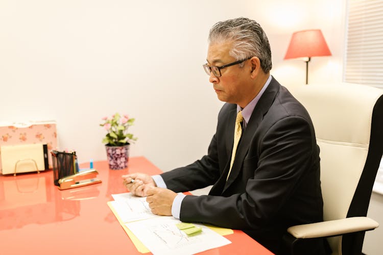 CEO In An Elegant Suit Sitting At His Desk