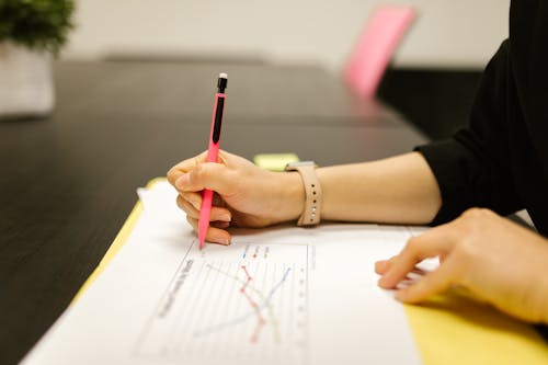 Close-Up Shot of a Person Writing on a Paper