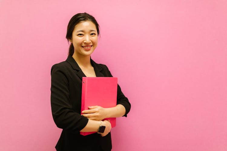 A Woman Holding A Binder