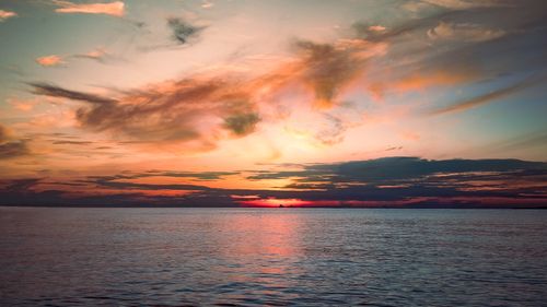 Free A breathtaking sunset over a calm ocean, showcasing vibrant colors and serene beauty. Stock Photo