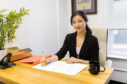 Free Woman in Black Blazer Sitting at the Table Stock Photo