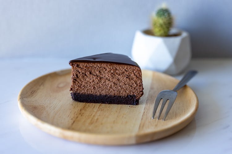 Slice Of Chocolate Cake On Round Wooden Tray