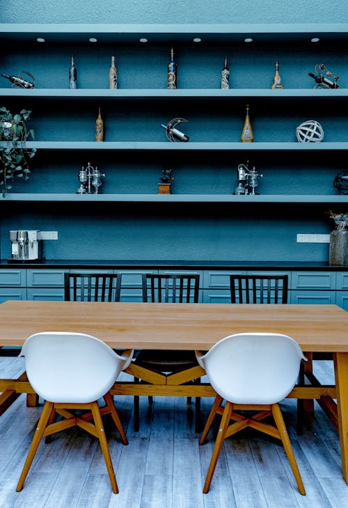 Stylish interior of dining room with wooden table and chairs