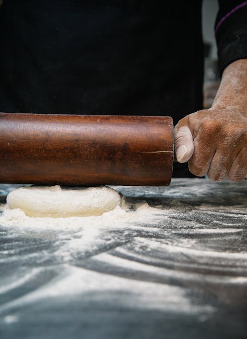 Free Person Using Brown Wooden Rolling Pin Stock Photo
