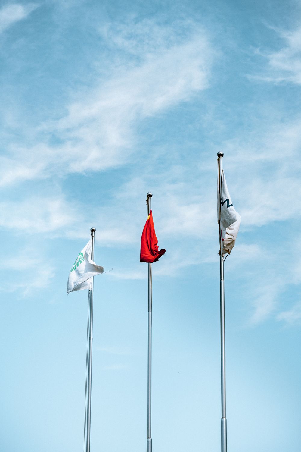 Flags Under a Blue Sky · Free Stock Photo