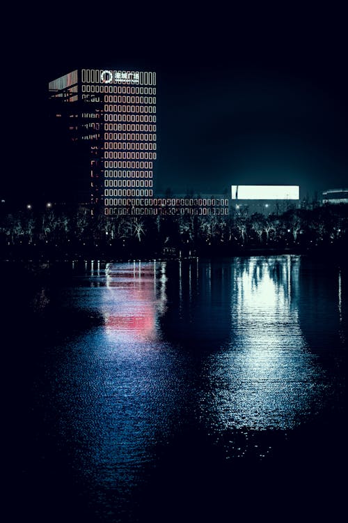 Body of Water with Reflections during Night Time
