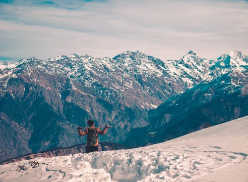 Man in a Mountain Valley Covered with Snow 