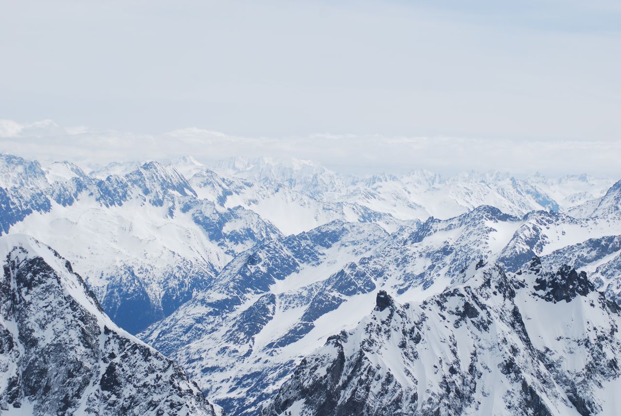 a stunning aerial view of a vast snow covered mountain range during wi