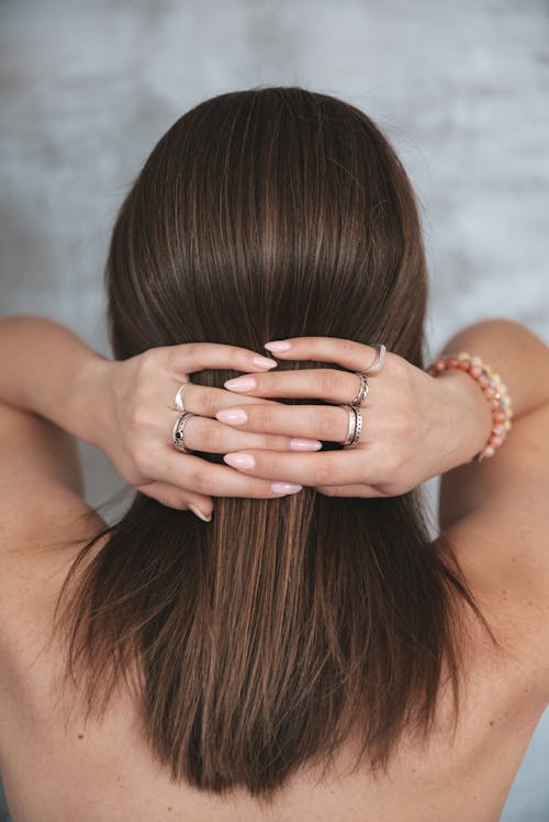Free Woman touching back of head with crossed hands Stock Photo