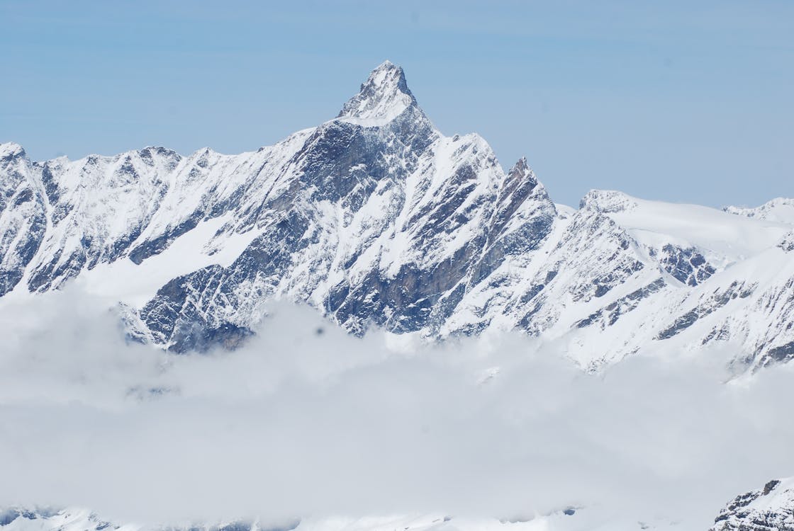 Mountain Peak Covered with Snow Under Blue Sky