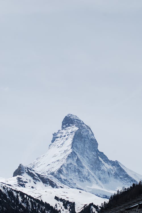 Snow Covered Mountain Under White Sky