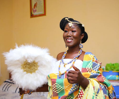 Adult Woman Wearing Colorful Clothing, Jewellery and Holding Plume