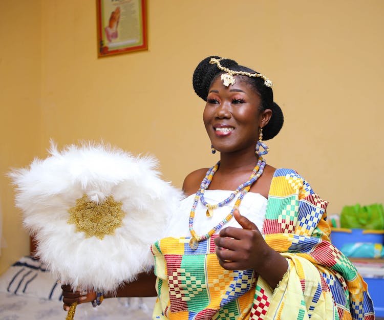 Adult Woman Wearing Colorful Clothing, Jewellery And Holding Plume