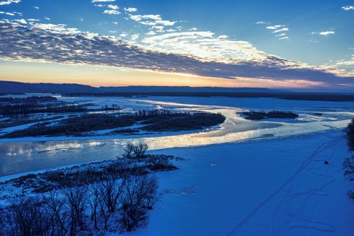 Free A stunning winter sunset casts vibrant colors over the frozen Mississippi River in Wabasha, MN, United States. Stock Photo