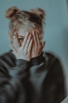 Man in Black and White Jacket Covering His Face
