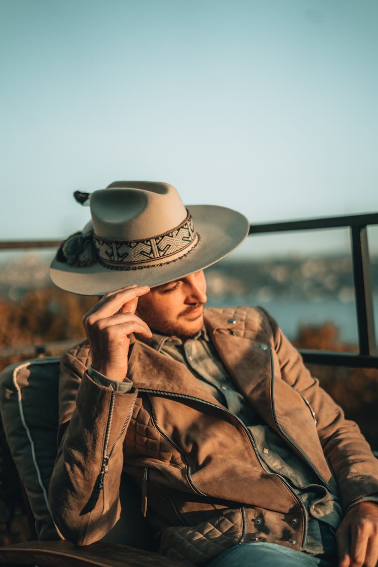 Man In Brown Leather Jacket And Brown Hat