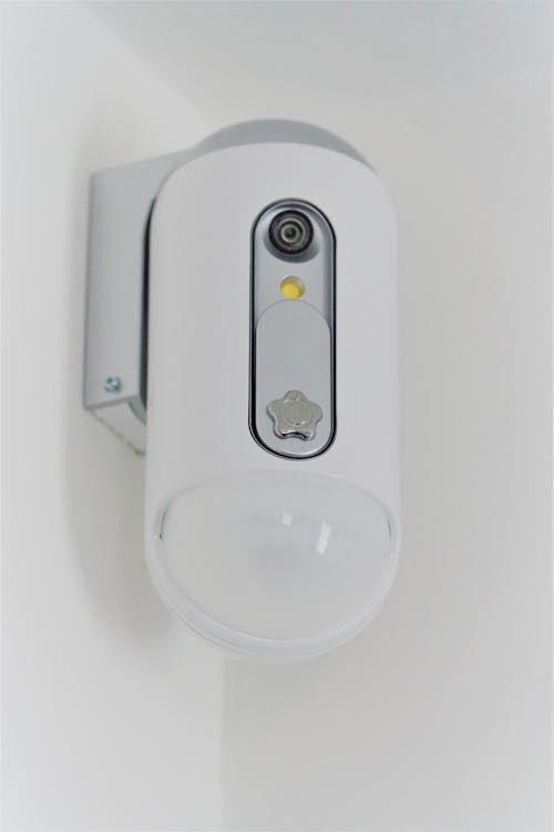 White Surveillance Camera Mounted on White wall