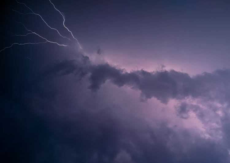 A Streak Of Lightning Behind Dark Clouds