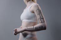 Woman in White Sports Bra and Panty With Body Paint