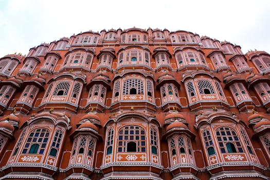 Low angle view of the iconic Hawa Mahal showcasing its elaborate facade in Jaipur, India.