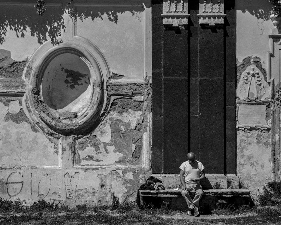 Man Sitting While Reading a Book 