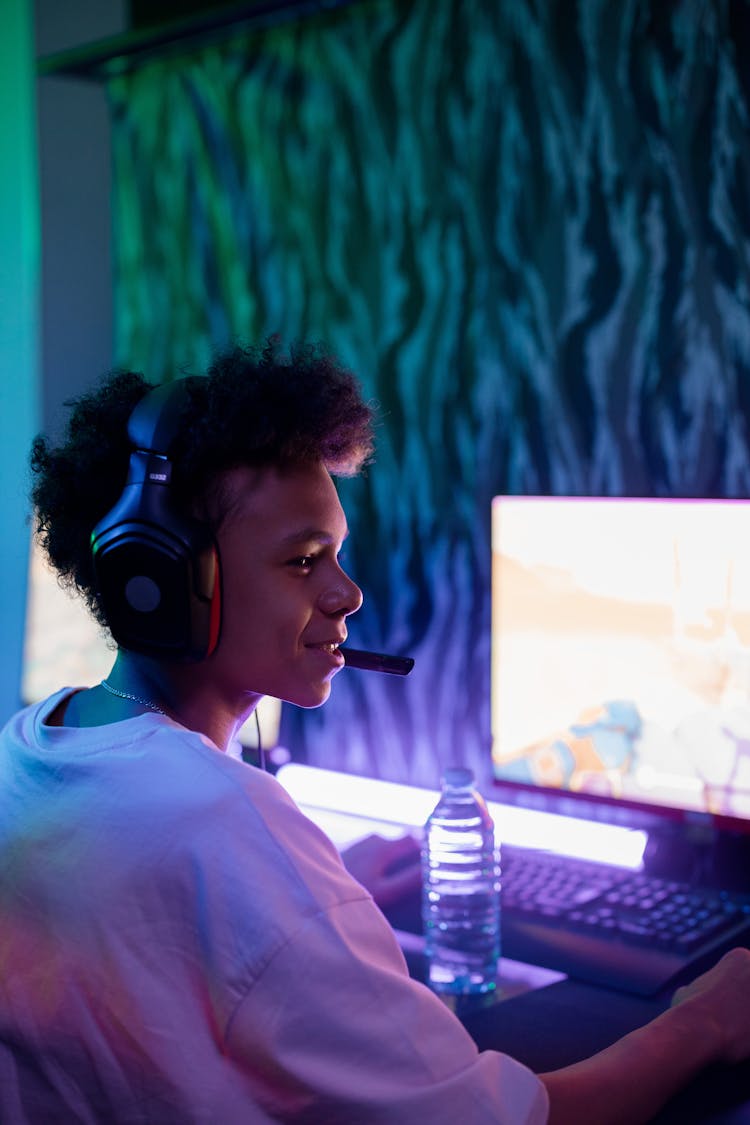 Boy In Front Of Computer With Black Headphones