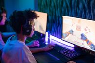 Boy with Black Headphones Playing Computer Game