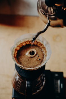 Detailed view of coffee being poured over in a filter, showcasing the brewing process.