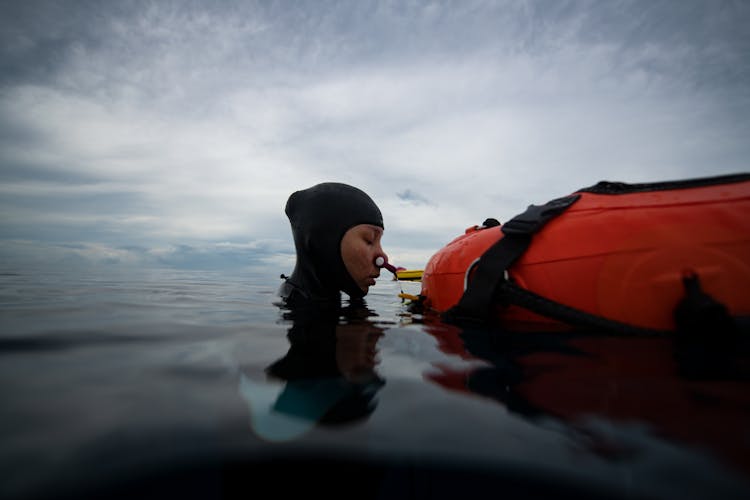 Unrecognizable Woman In Wetsuit Preparing For Diving