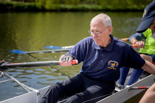 Senior Man Rowing on a Canoe on River 