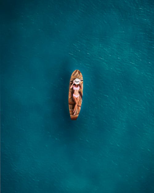 A Woman Lying Down on a Surfboard