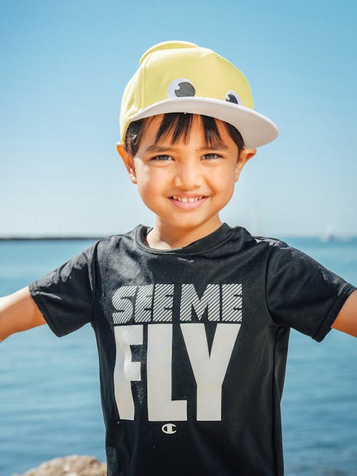Boy in Black Crew Neck T-shirt Wearing a Cap